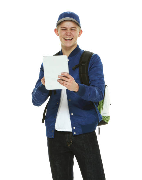 istock Caucasian boys student in front of white background wearing backpack and holding textbook 1209152605