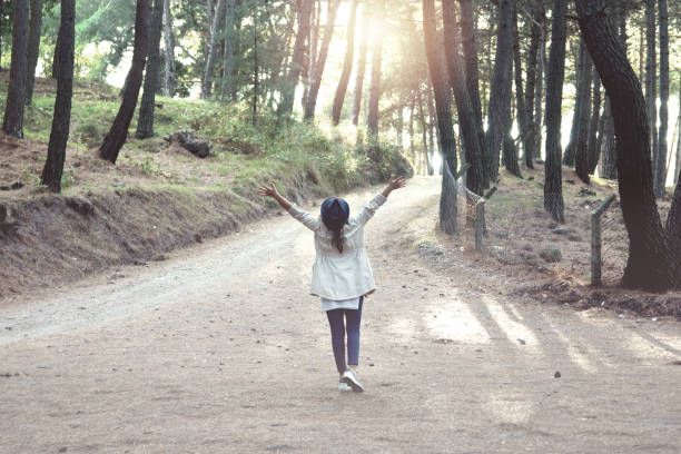 istock Young woman with hat enjoying nature in  forest 1209152818