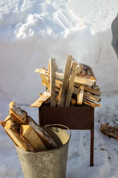 Photo of Barbecue with wood in winter on the street. Fry kebabs