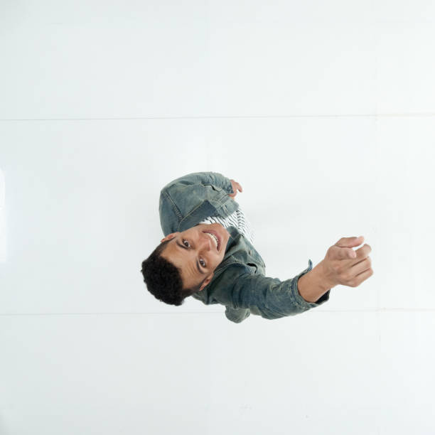 istock Young male in front of white background wearing denim jacket 1209155370