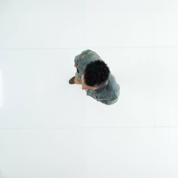 istock Young male in front of white background wearing denim jacket 1209155378