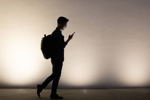 istock silhouette of man use phone 1209155390