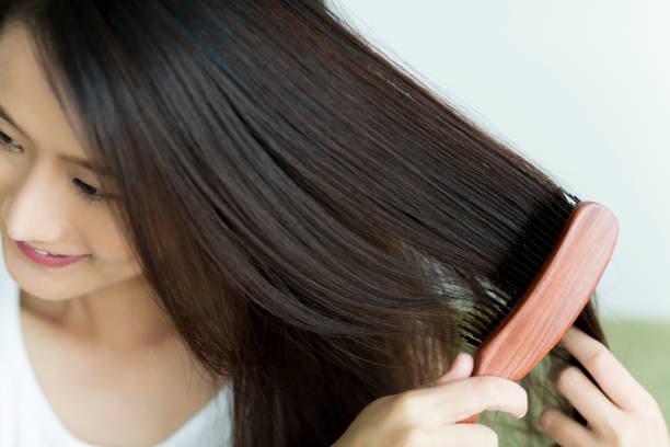 Young woman brushing hair stock photo