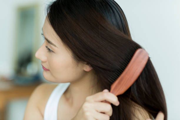 istock Young woman brushing hair 1209159295