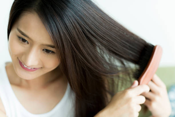 istock Young woman brushing hair 1209159298