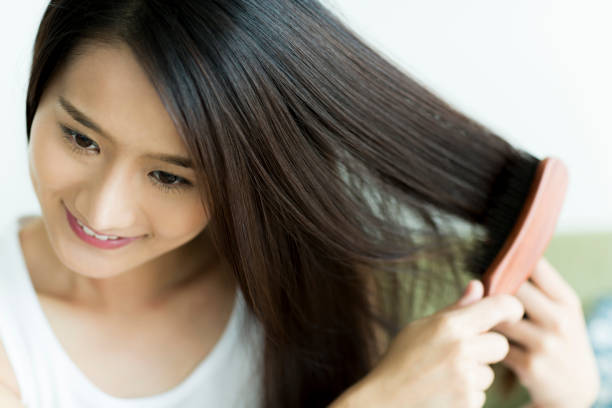 Young woman brushing hair Person human hair women brushing beauty stock pictures, royalty-free photos & images