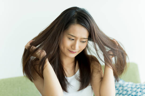 istock Young woman touching her hair 1209159332