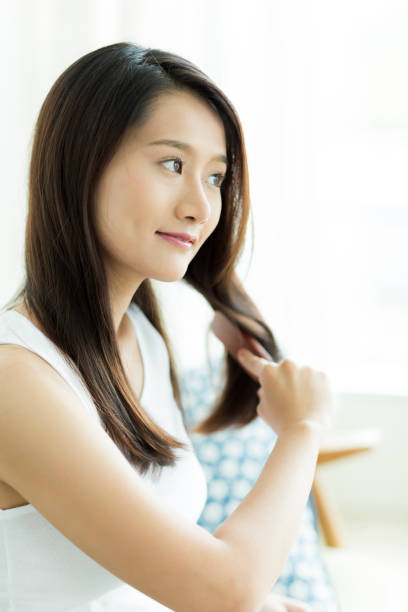 istock Young woman brushing hair 1209159333