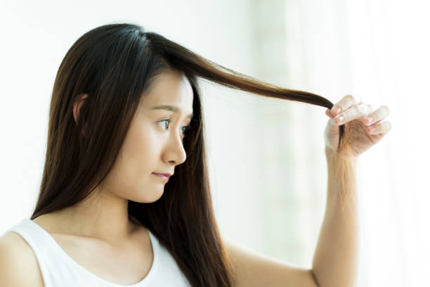 istock Young woman touching her hair 1209159365