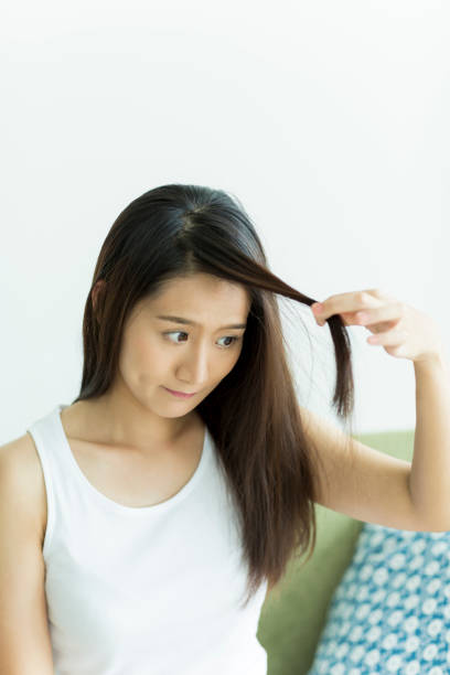 istock Young woman touching her hair 1209159368