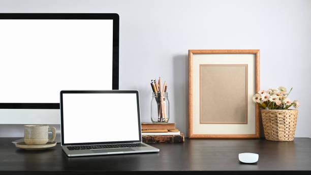 istock An Orderly workplace with laptop and pc computer and accessories putting together on it. 1209159826