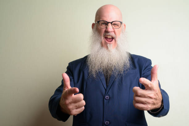 istock Angry mature bearded bald businessman shouting and screaming at camera 1209161205