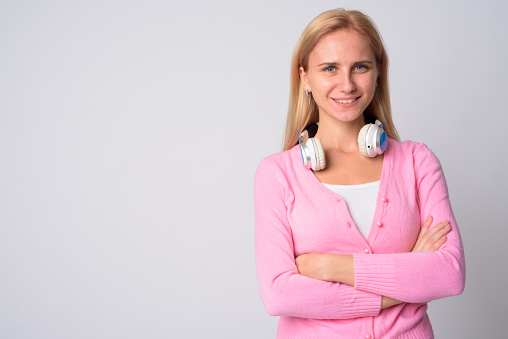 Studio shot of young beautiful woman with blond hair against white background