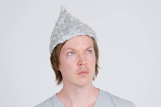 istock Face of young man with tinfoil hat thinking as conspiracy theory concept 1209163150