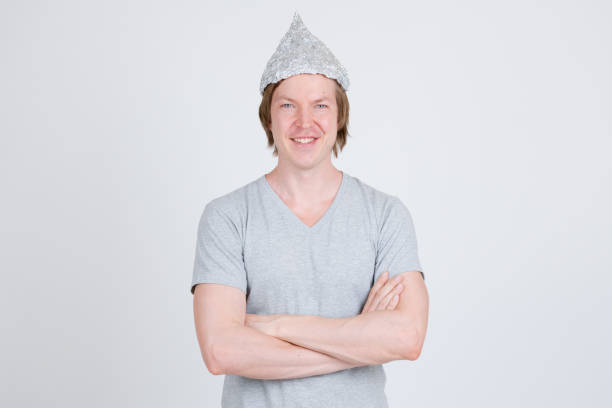 istock Happy young man with tinfoil hat as conspiracy theory concept 1209163155