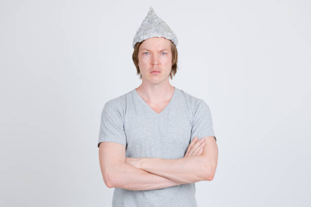 istock Young man with tinfoil hat as conspiracy theory concept 1209163183