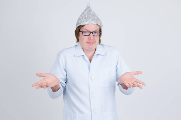 istock Young man doctor with tinfoil hat shrugging shoulders 1209163571