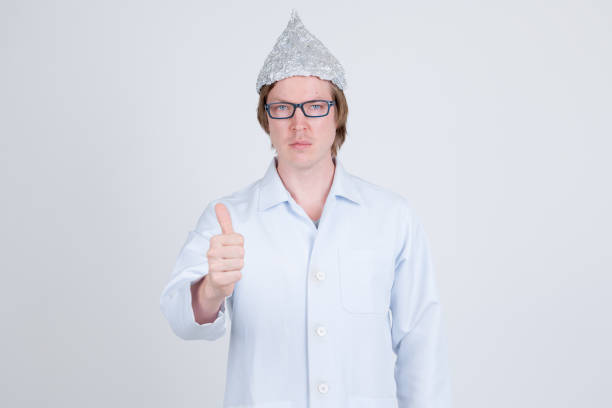 istock Young man doctor with tinfoil hat giving thumbs up 1209163731