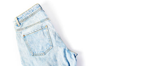istock folded blue jeans on a white background. modern casual clothing. flat lay, copy space 1209169828