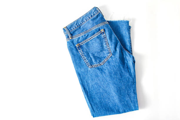 istock dark blue denim pants on a white background. minimalistic fashion concept. flat lay, copy space 1209169837