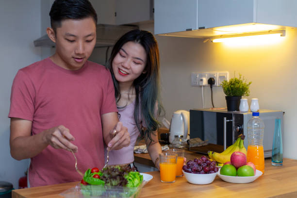 istock Asian couple cooking in the kitchen 1209171727