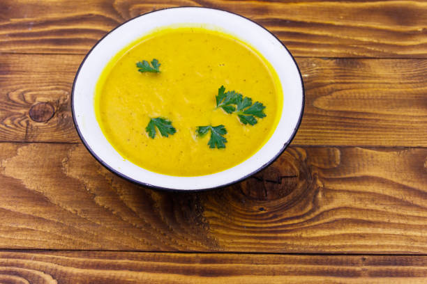 istock Pumpkin soup on a wooden table 1209172504