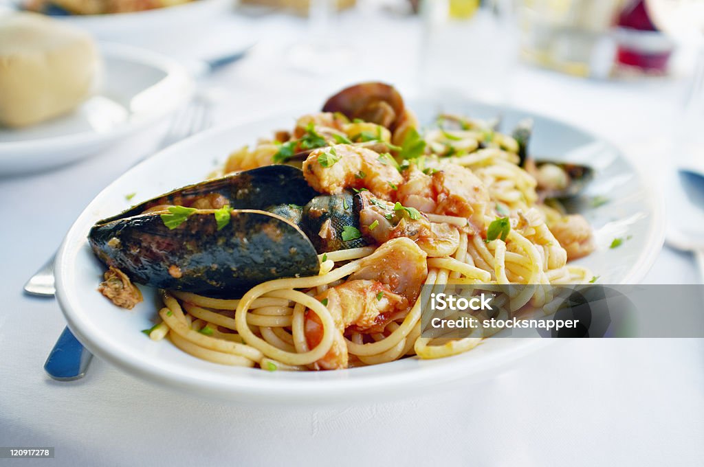 Fresh seafood pasta Fresh Seafood pasta - Spaghetti, clams, shrimps and squid, served in a restaurant in Burano, Veneto, Italy. Seafood Stock Photo