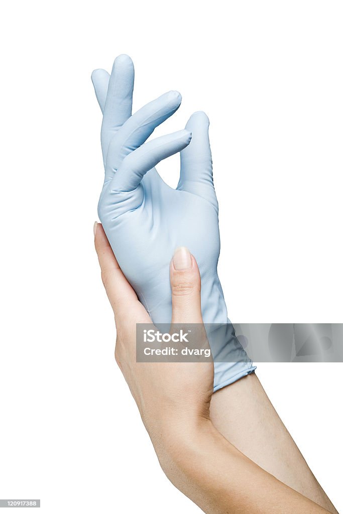 Blue gloved hand Woman hand putting on surgical glove Assistance Stock Photo