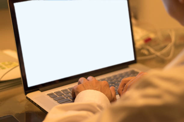 Business man hard working concept. Back of businessman work on multichannel devices notebook laptop computer and smartphone at night using 5g and wireless wifi network from home