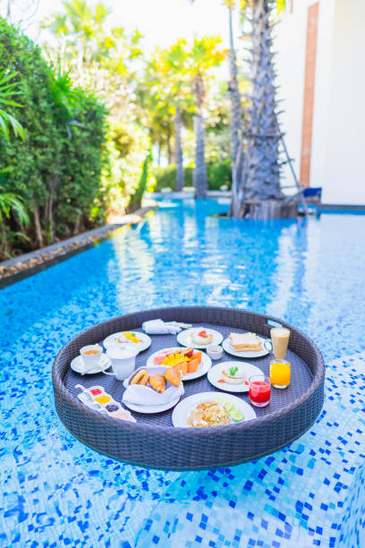 istock Floating breakfast set in tray with fried egg omelette sausage ham bread fruit milk juice coffee 1209176758