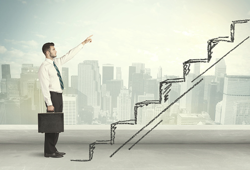 Business man climbing up on hand drawn staircase concept on city background