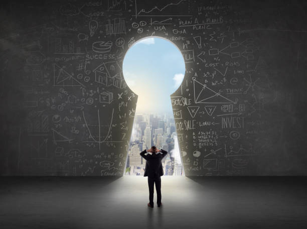 istock Business man looking at keyhole with bright cityscape concept 1209179681
