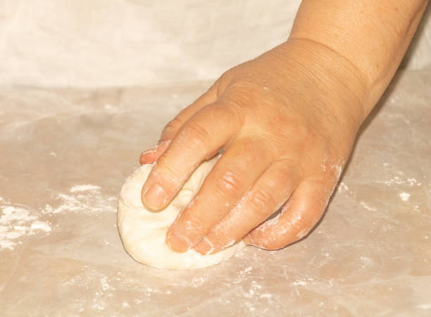 istock Cooking dough in process. Woman hand cooking 1209181012