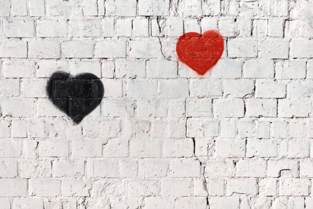 istock red and black heart on old white painted brick wall 1209181196