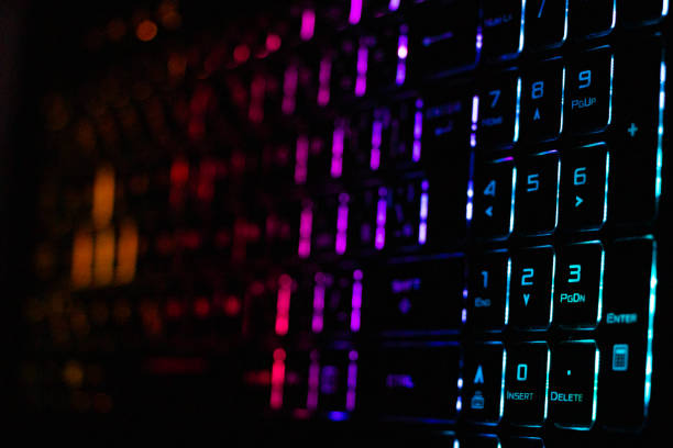 istock Colorful modern keyboard with rainbow backlight on black background 1209183319