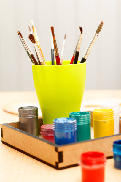 istock Paints and brushes in a cup ready for painting 1209184498