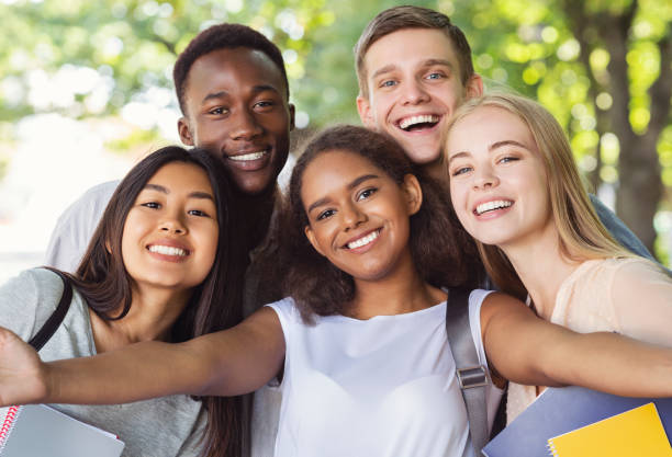 istock Cheerful group of friends taking selfie while walking in park 1209184684