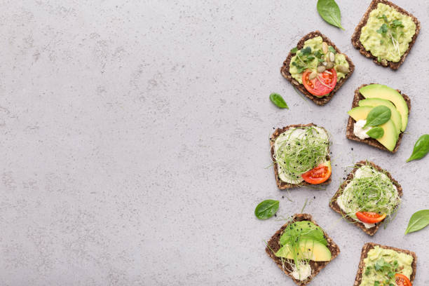 istock Sandwiches with vegetables, baby spinach and seeds 1209184715