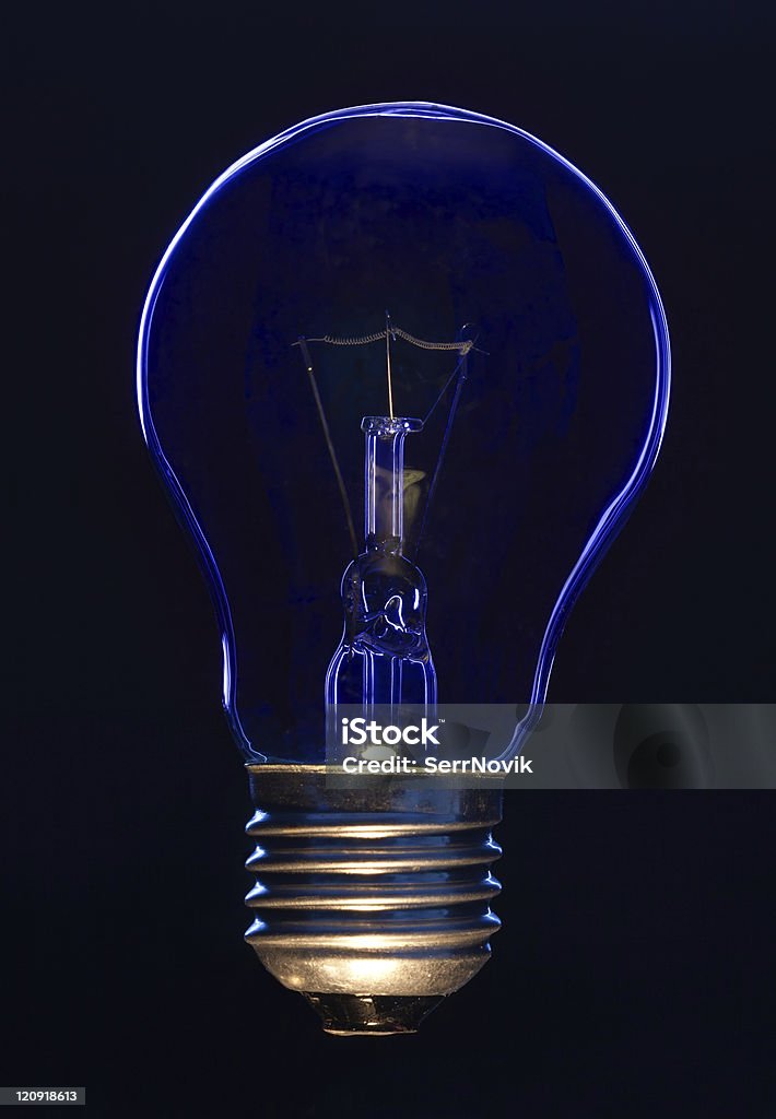 Light bulb Light bulb on black background lit with blue light Black Background Stock Photo