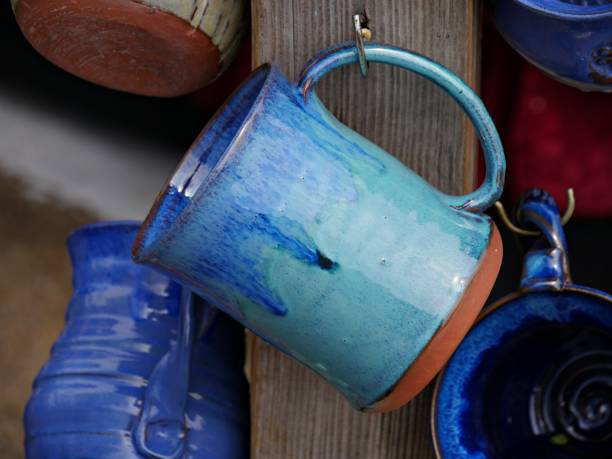 Hand-made, hand-painted ceramic mugs on display at a festival