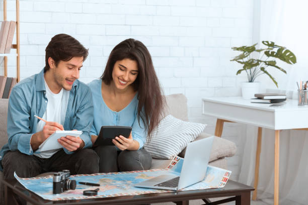 Plan finances. Couple preparing for vacation and calculating expenses
