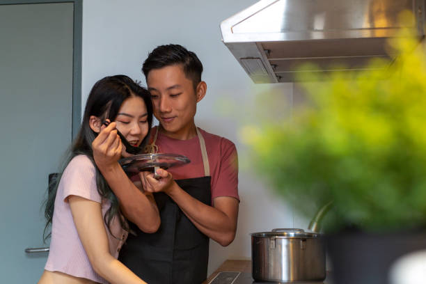 istock loving young couple cooking together in the kitchen 1209187779