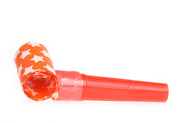 A red party horn blower with white stars on white background stock photo