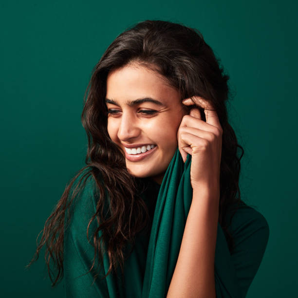 She's beautiful in every single way Shot of a beautiful young woman posing against a green background west asian ethnicity photos stock pictures, royalty-free photos & images