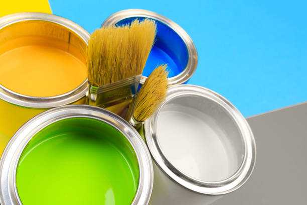 istock Metal paint cans and paint brushes on multicolor background. Top view. Copy space. 1209189309