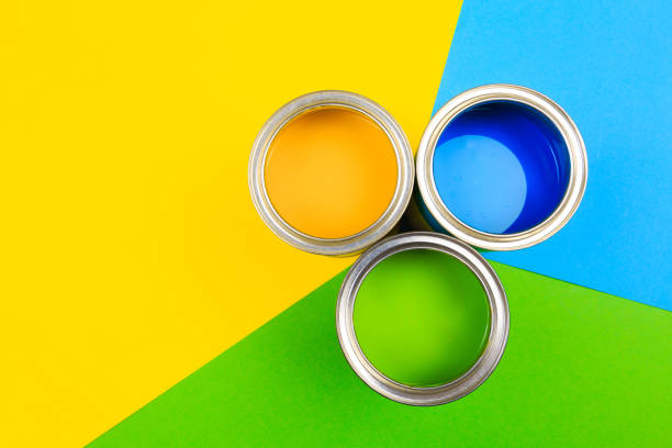 istock Metal paint cans and paint brushes on multicolor background. Top view. Copy space. 1209190957
