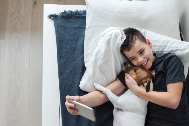 istock A young boy takes a selfie with a dog. 1209191110