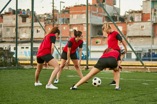 istock Hispanic Female Footballers Stretching Before Practice 1209195036