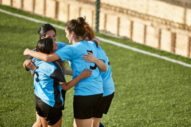 istock Four Hispanic Footballers Hugging After Scoring Goal 1209195058