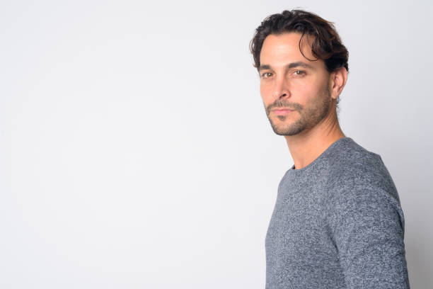 istock Closeup profile view of handsome Hispanic man looking at camera 1209197063